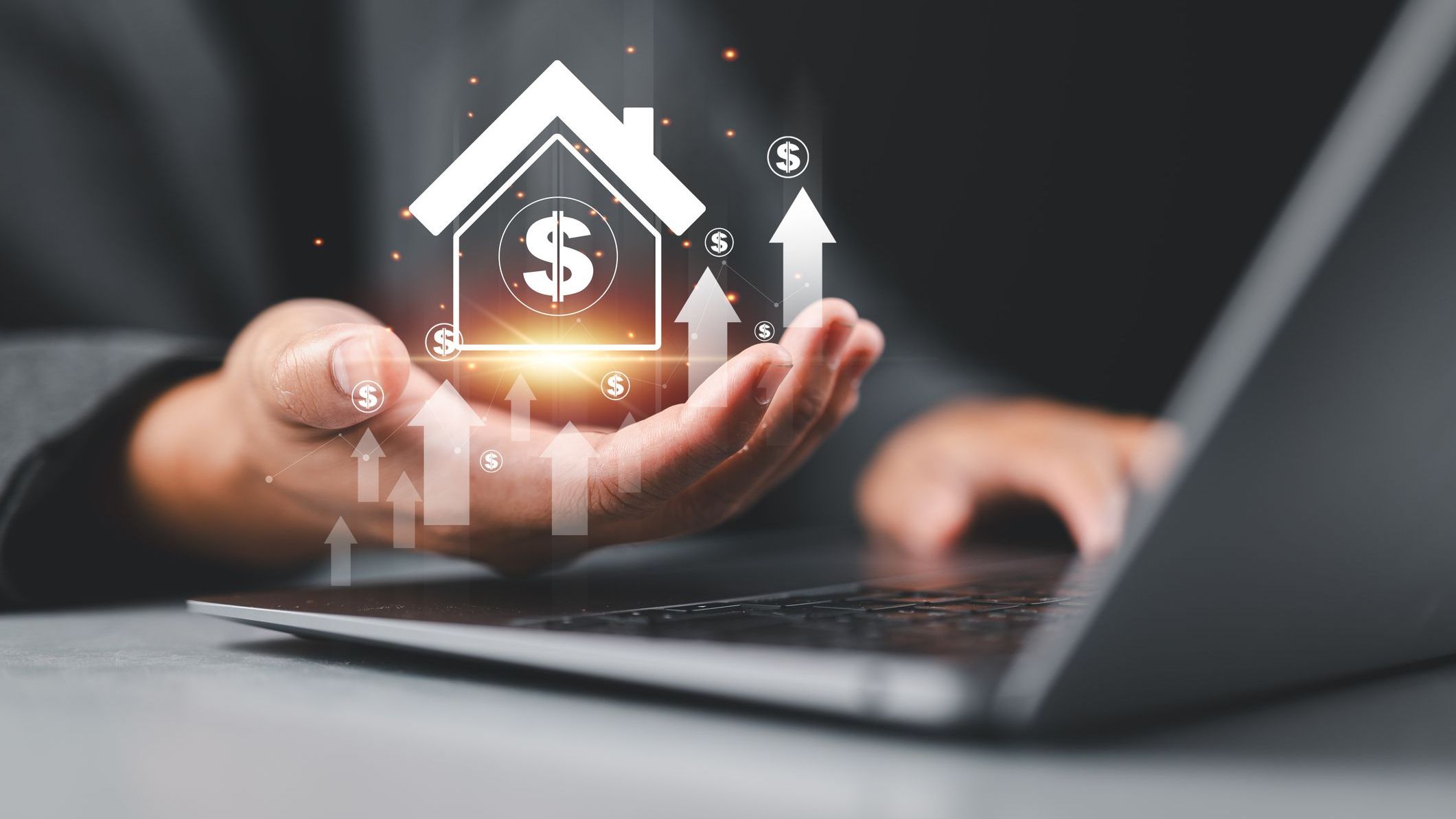 A man holding a virtual house icon with dollar signs and upward arrows.