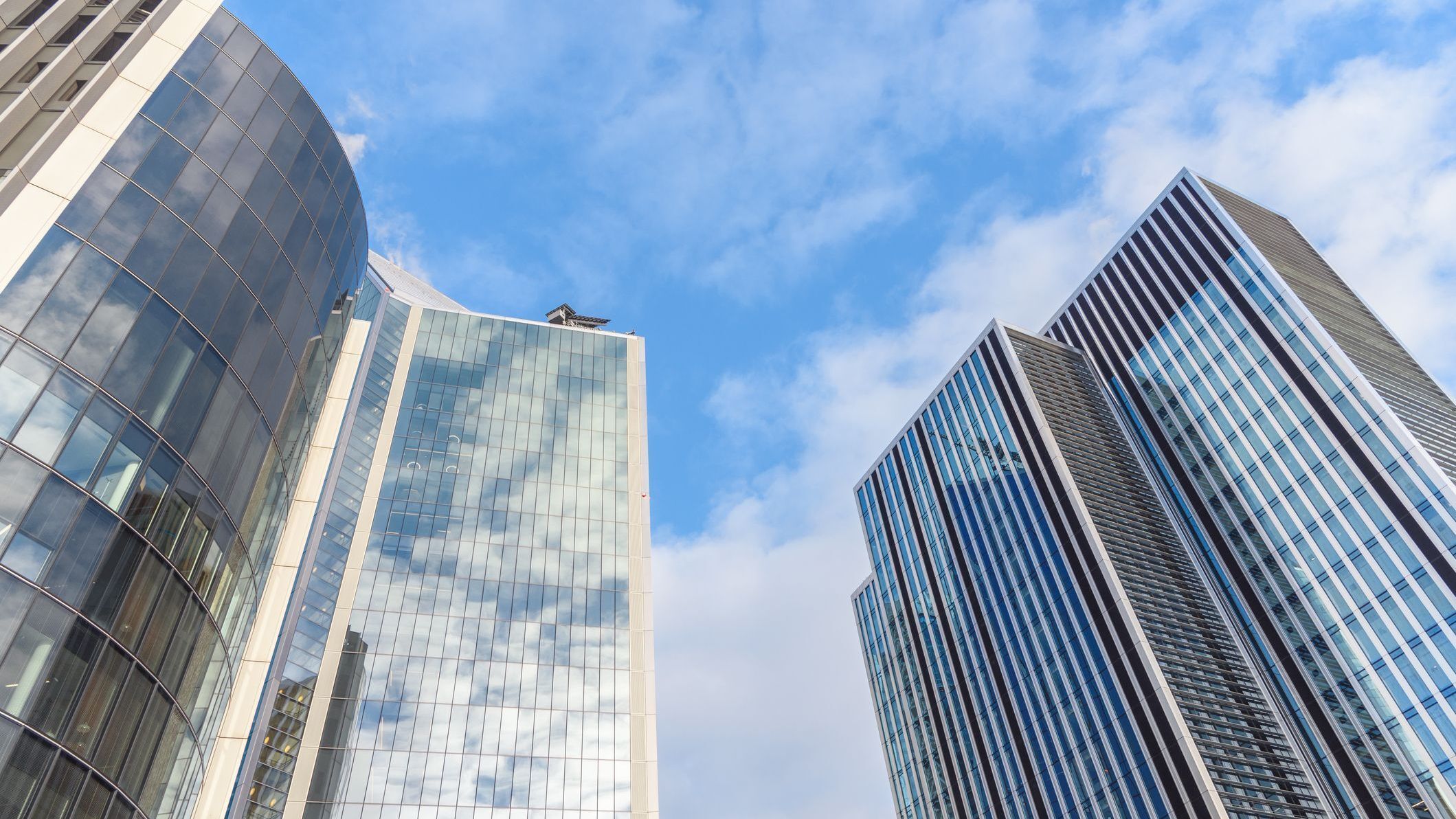 Low angle view of steel and glass skyscrapers in the City of London on a sunny winter day.