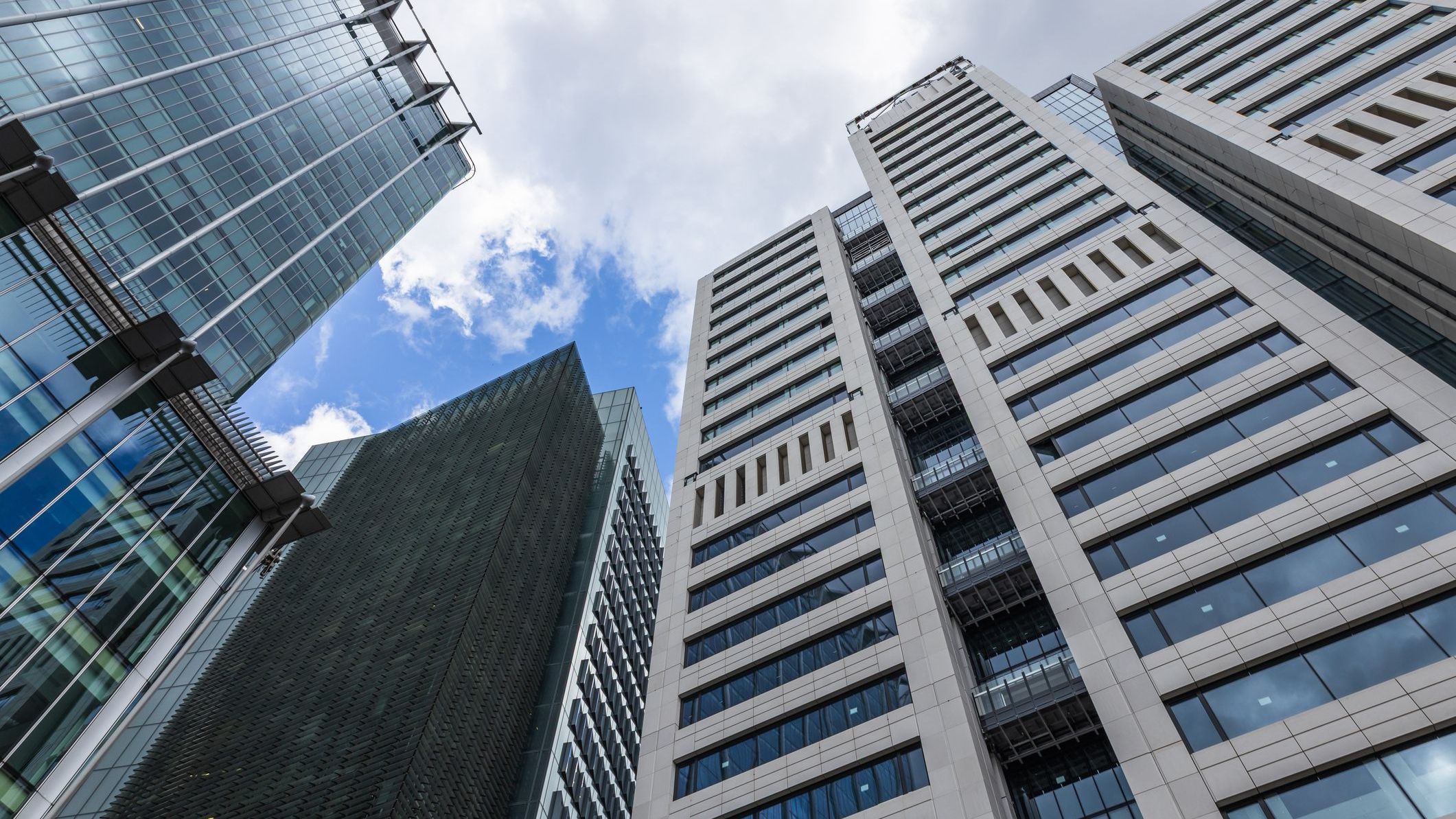 Modern glass skyscrapers and office towers from below in a corporate business district 